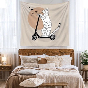 Close-up of bohemian wall tapestry featuring a minimalist cat riding a black scooter