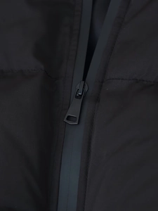 Detail of waterproof matte black zipper and high-quality textured fabric on puffer jacket