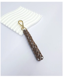 Detailed view of handmade dark brown braided keychain with golden lobster metal clasp