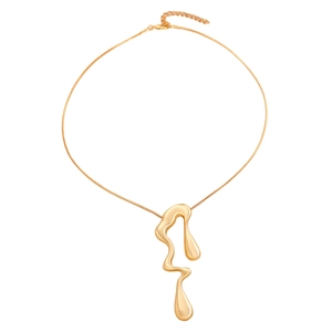 Macro detail of golden irregular lava liquid metal pendant necklace with glossy finish