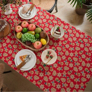 Red Christmas tablecloth with gingerbread man and snowflake prints for holiday dining