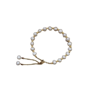 Elegant adjustable freshwater pearl bracelet with gold metal beads on a clean white background