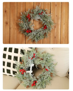 Close-up of artificial Christmas wreath with red berries, pine cones and green needles