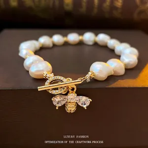Baroque freshwater pearl bracelet with zircon bee charm and golden T-bar toggle clasp