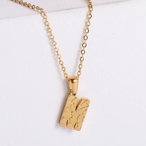 18K gold plated stainless steel letter M pendant necklace with stone texture on white background