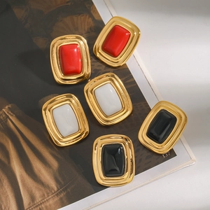 Macro view of vintage rectangular stainless steel earrings in red white and black