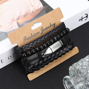 Gros plan de bracelets en cuir noir pour hommes avec perles et pendentif balle