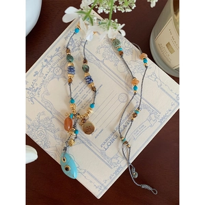 Detailed close-up of colorful turquoise beads and vintage bohemian style pendant necklace