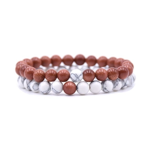 Macro detail of elastic bead bracelets with brown goldstone and white turquoise stones