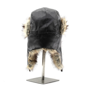Close-up of winter aviator hat featuring black faux leather and thick brown faux fur lining