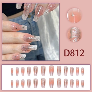 Detail of pink gradient press-on nails with silver butterflies and rhinestone accents