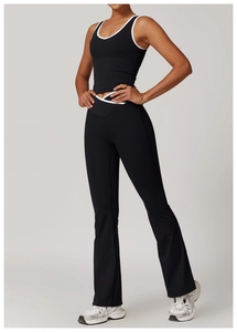 Detail of high-waisted flared yoga pants and racerback top with contrast white piping