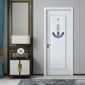 DIY diamond art painting anchor with nautical elements hanging on a white wooden door