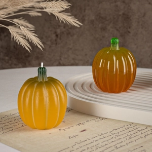 Artistic display of 3D pumpkin candles with a matte yellow finish and resin texture