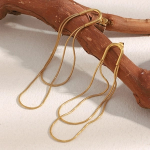 Minimalist long tassel earrings with 18K gold plated snake chains on wooden branch