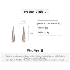 Detailed macro view of 6cm polished iron teardrop earrings showing shiny metallic texture
