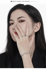 Close-up of S925 sterling silver wavy ring and bracelet with frosted texture on model