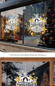 Detailed view of gold and white Merry Christmas static stickers on window glass