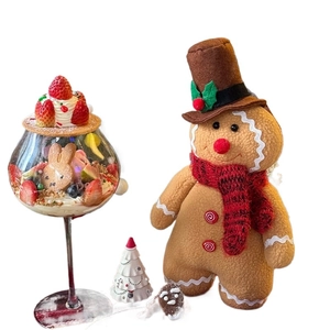 Standing gingerbread man plush toy and dessert glass display for Christmas decor