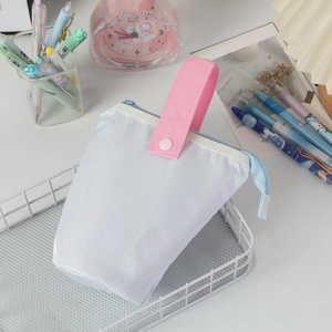 Detailed close-up of large capacity canvas pencil case with pink handle and blue zipper