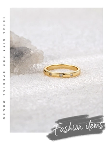 Detailed macro of 18K gold plated ring with three tiny cubic zirconia stones on crystals
