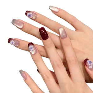 Handmade burgundy and lilac cat-eye press-on nails with 3D floral accents and pearls