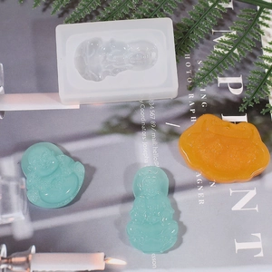 Translucent silicone mold for DIY Buddha and Ruyi pendants with finished resin charms