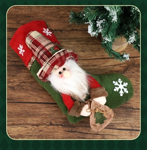 Detail of green felt Christmas stocking with 3D Santa and rustic wood background