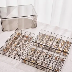 Three-layer clear acrylic jewelry organizer with gray drawers for rings and earrings