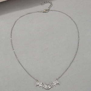 Detail of gothic silver bat pendant with intricate wing texture and lobster clasp chain