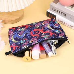 Detailed view of makeup bag with traditional Chinese dragon pattern and black zipper