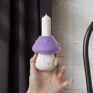 Detailed view of mushroom candle holder with purple spotted cap and textured white stem