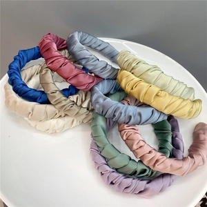 French vintage pleated satin headbands in multiple pastel colors on a white plate