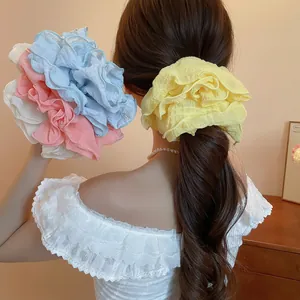 Elegant oversized ruffled fabric scrunchie set in pastel yellow, blue, pink and white