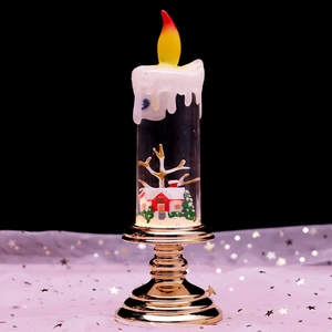 Macro detail of Christmas LED lantern showing miniature house, snow, and golden base