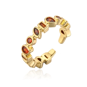 Detail of 18K gold plated ring featuring multi-shaped amber cubic zirconia stones