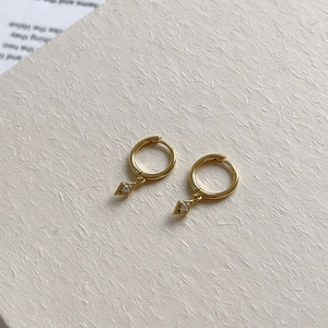 Detailed view of S925 sterling silver rhombus earrings with gold finish and zircon stones