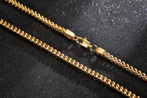 Close-up of golden stainless steel Franco chain with a secure lobster clasp closure