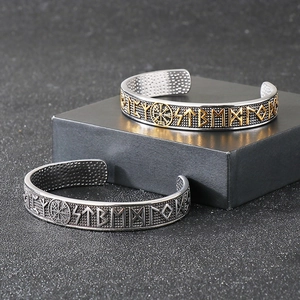 Detail of Viking compass bangles featuring Nordic runes in silver and two-tone finishes
