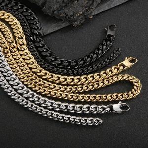 Polished stainless steel Cuban link chains in gold, black, and silver for men on dark stone