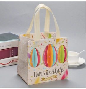 Detail of Happy Easter gift bag with colorful eggs and yellow handles in home setting