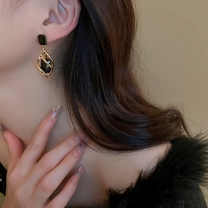 Vintage gold hollow geometric drop earrings with black stone on model for women