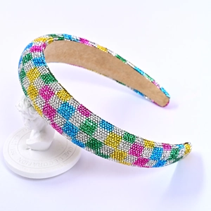 Macro view of wide headband with colorful rhinestones in a checkerboard pattern