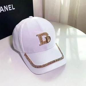 Stylish white cotton baseball cap featuring gold rhinestone letter D and brim accents