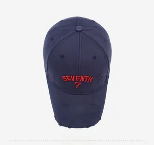Detailed top view of navy blue distressed baseball cap with red SEVENTH 7 embroidery