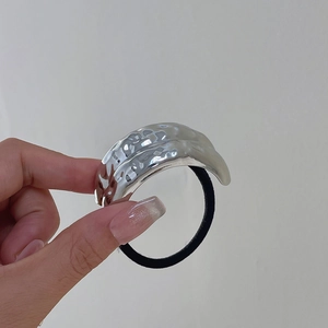 Detail of silver hammered metal hair tie with high elastic black band for women