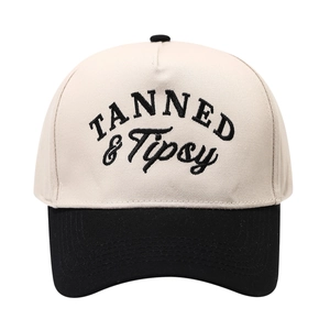 Two-tone beige and black baseball cap with Tanned & Tipsy embroidery on the front