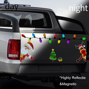 Day and night comparison of reflective Christmas magnetic car decals on a truck tailgate