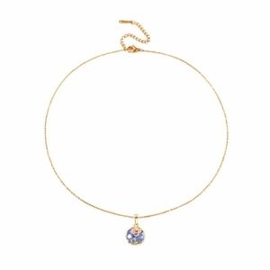 Detailed macro view of the gold necklace with a round floral enamel pendant design