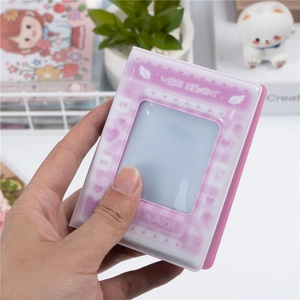 Detail of 3-inch mini photo album featuring heart window and cute pastel wing design